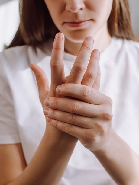 Woman holding painful wrist looking for carpal tunnel relief